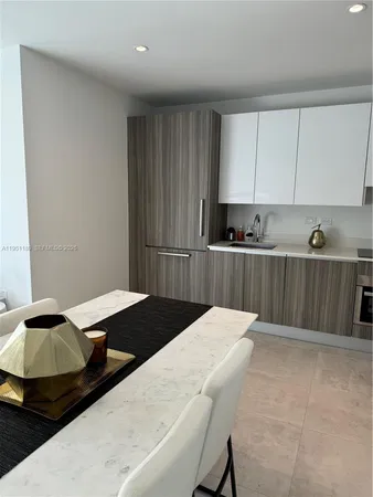 a kitchen with a table and chairs