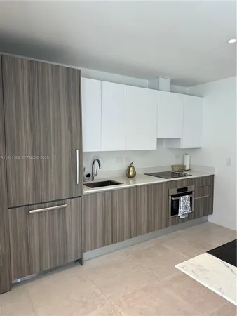 a kitchen with stainless steel appliances granite countertop a refrigerator sink and cabinets