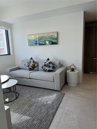 a living room with furniture and wall painting