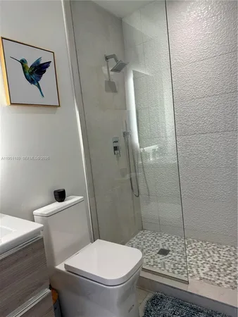 a white toilet sitting next to a bathroom sink