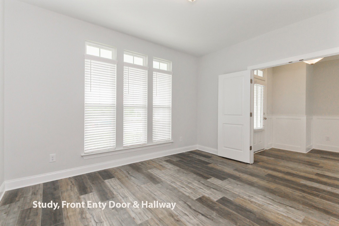 653 Castle Road Mount Juliet, TN 37122 - Photo 4 of 29 an empty room with wooden floor and windows