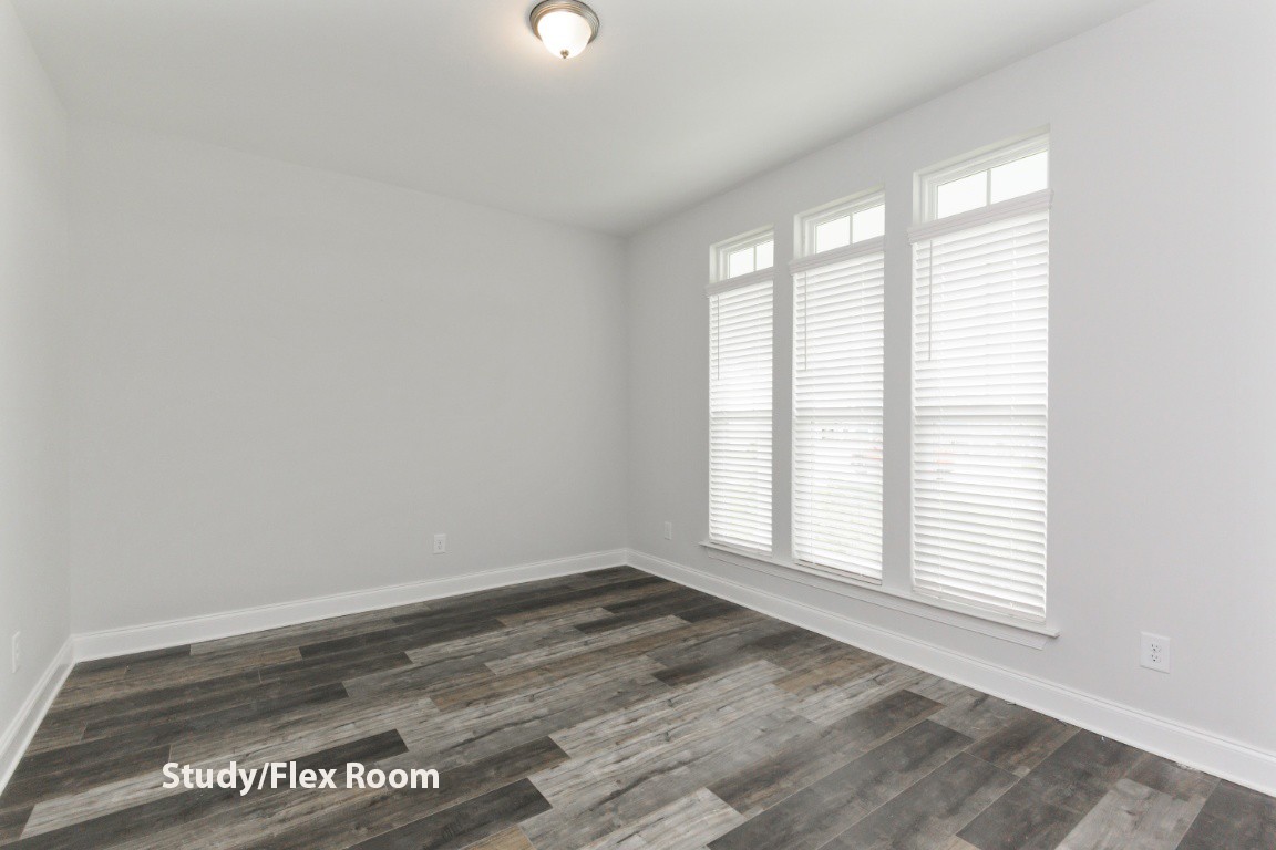 653 Castle Road Mount Juliet, TN 37122 - Photo 5 of 29 an empty room with wooden floor and windows
