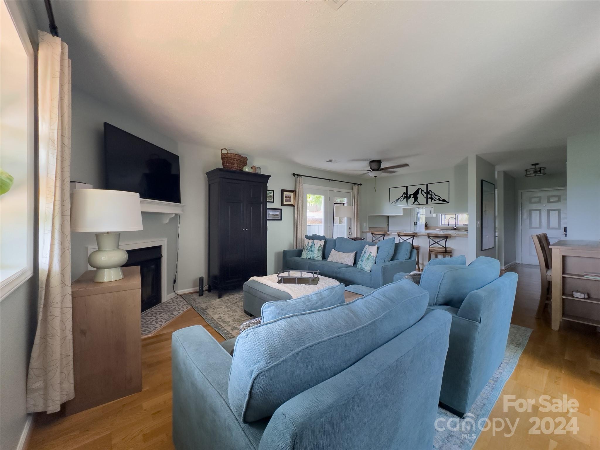 907 Victory Trail Morganton, NC 28655 - Photo 13 of 32 a living room with furniture a fireplace and a flat screen tv