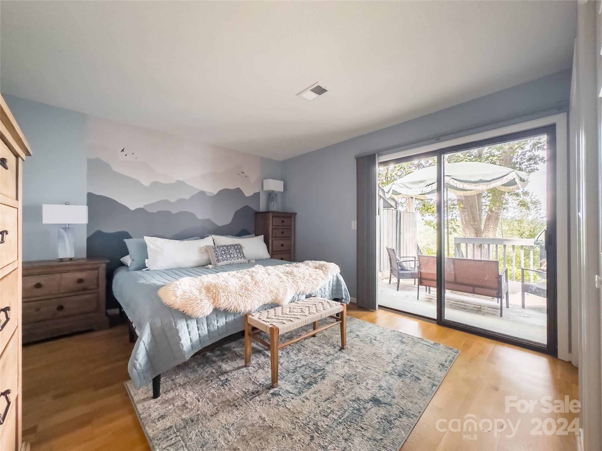 907 Victory Trail Morganton, NC 28655 - Photo 18 of 32 a bed sitting in a bedroom next to a window