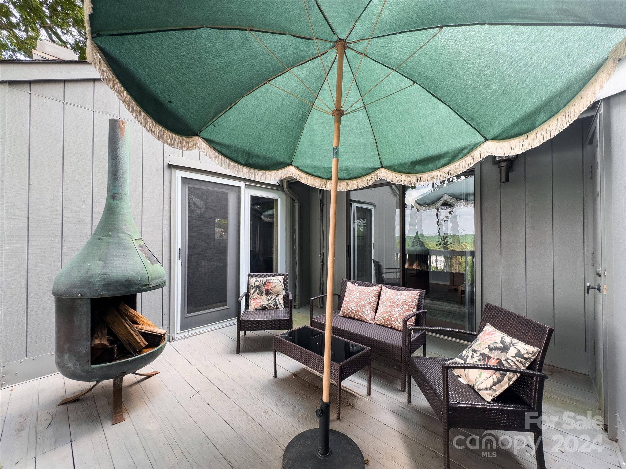 907 Victory Trail Morganton, NC 28655 - Photo 20 of 32 a patio with patio table and chairs under an umbrella