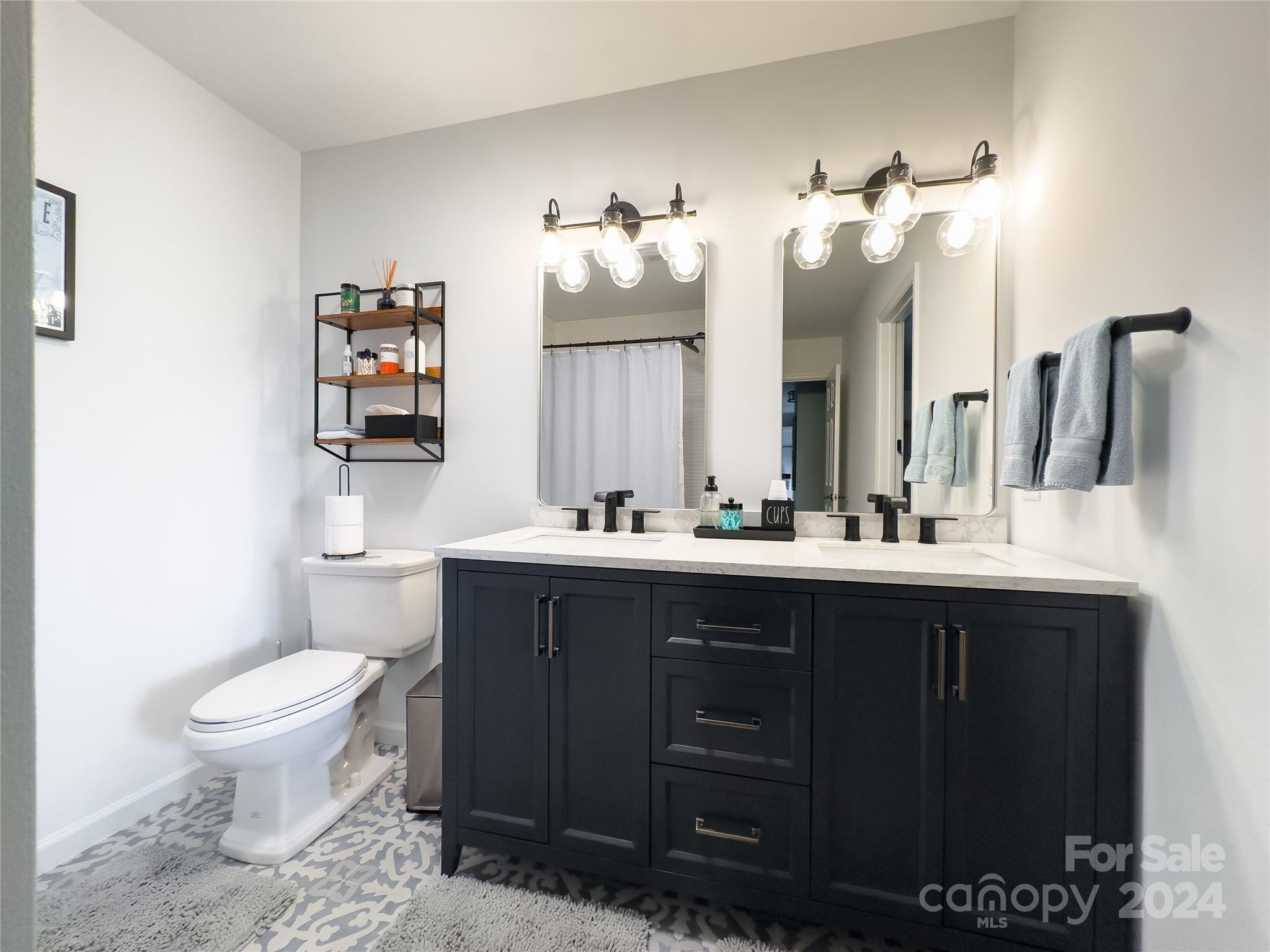907 Victory Trail Morganton, NC 28655 - Photo 22 of 32 a bathroom with a sink vanity mirror and toilet