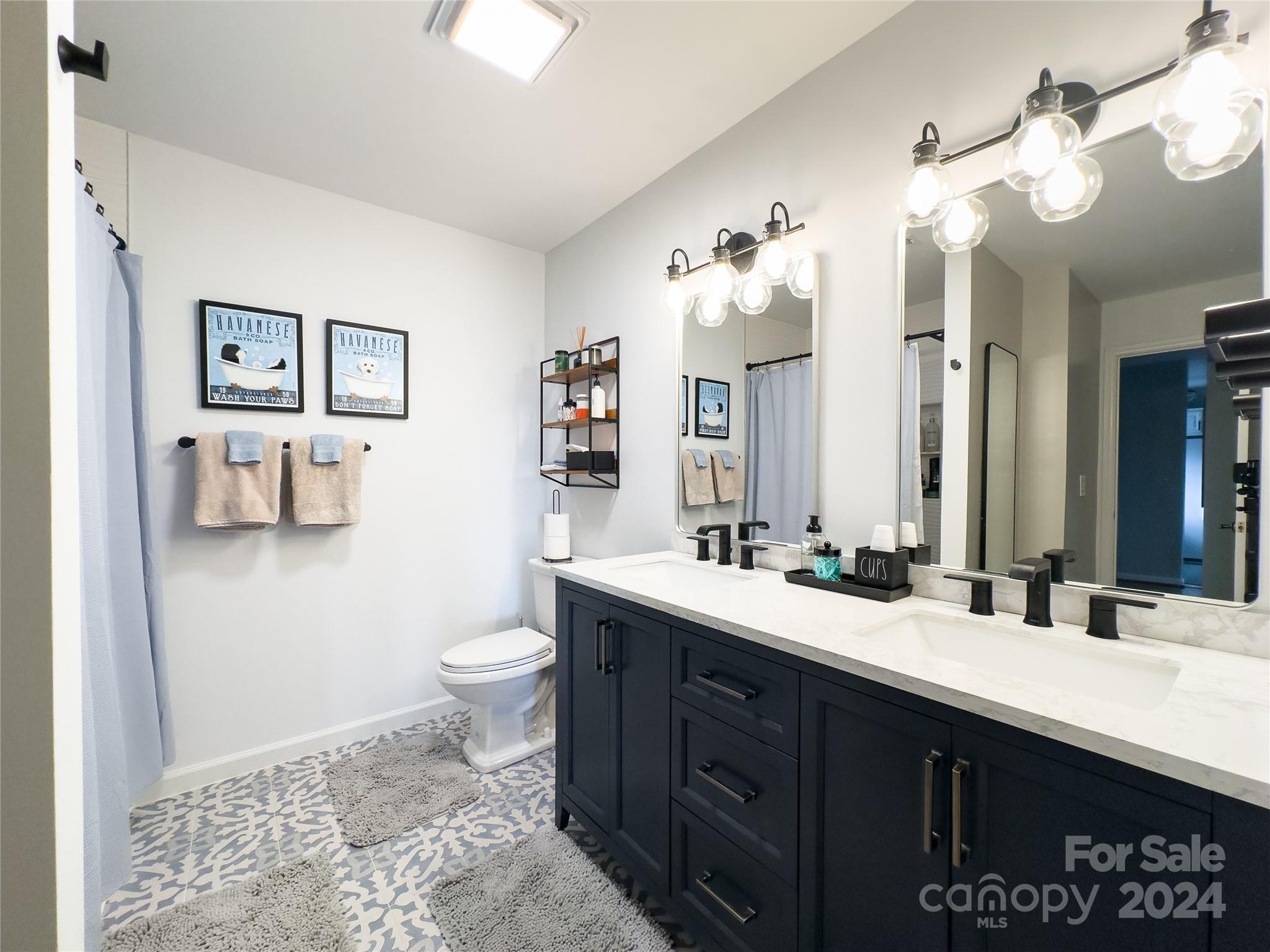 907 Victory Trail Morganton, NC 28655 - Photo 23 of 32 a bathroom with a double vanity sink mirror and toilet