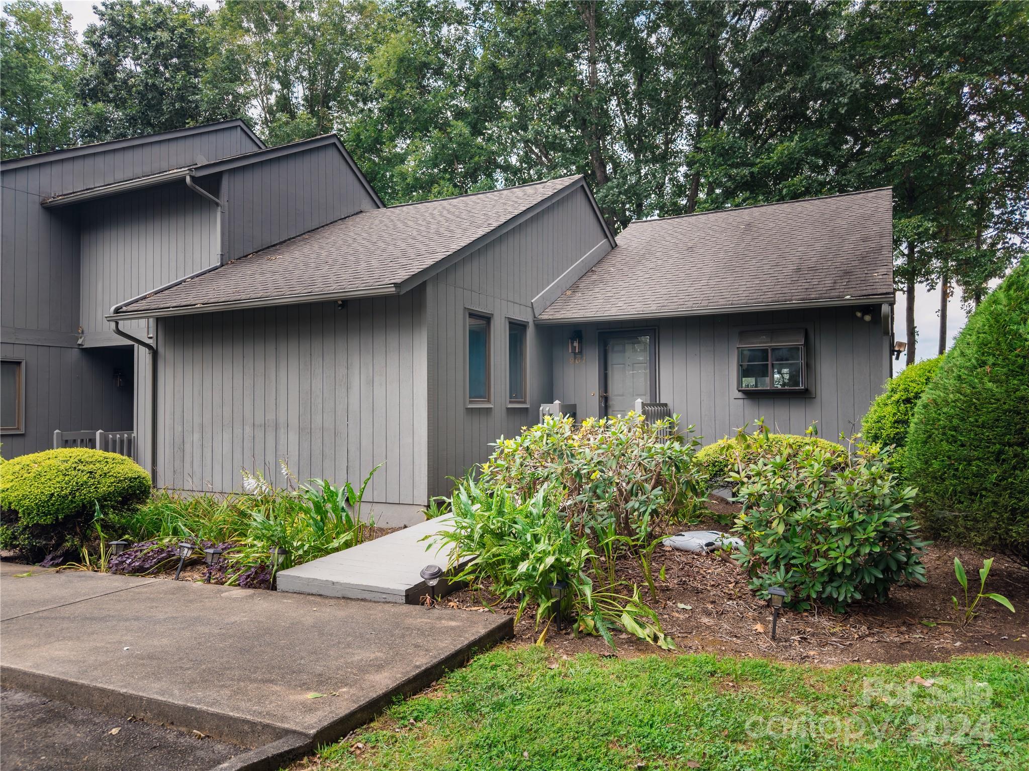 907 Victory Trail Morganton, NC 28655 - Photo 30 of 32 a view of a house with a small yard plants and large tree