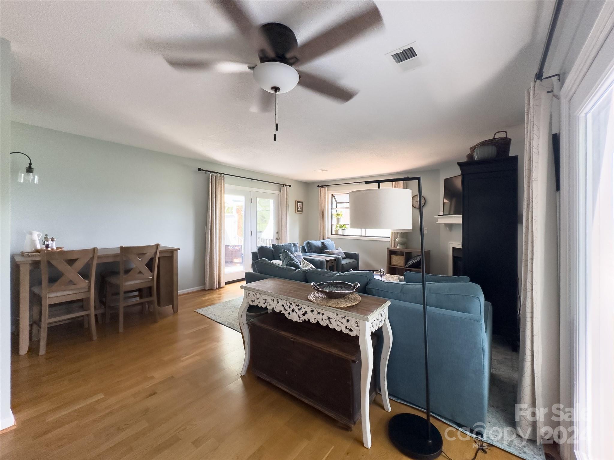 907 Victory Trail Morganton, NC 28655 - Photo 10 of 32 a living room with furniture a dining table and a flat screen tv