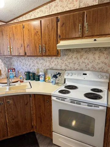 a kitchen with a stove and a microwave