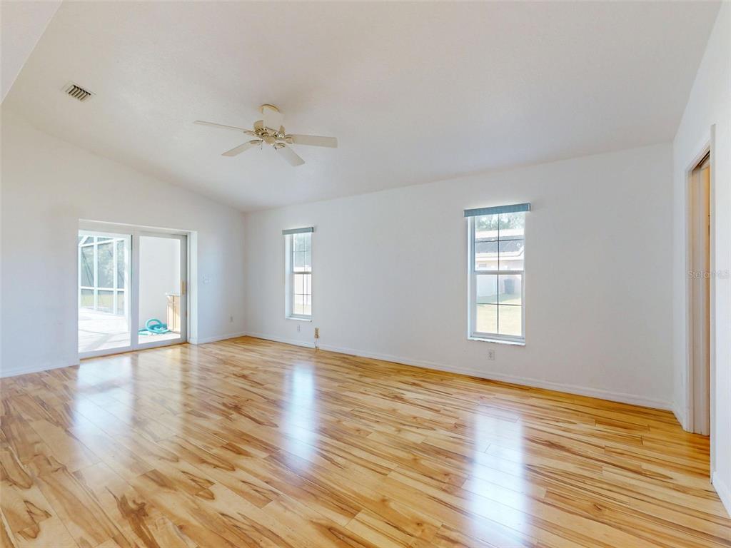7558 Southwest 103rd Loop Ocala, FL 34476 - Photo 11 of 38 a view of an empty room with window and wooden floor