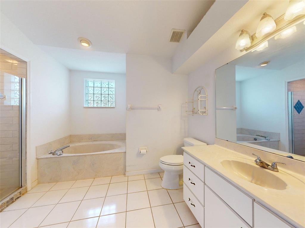 7558 Southwest 103rd Loop Ocala, FL 34476 - Photo 14 of 38 a bathroom with a sink a toilet and bathtub