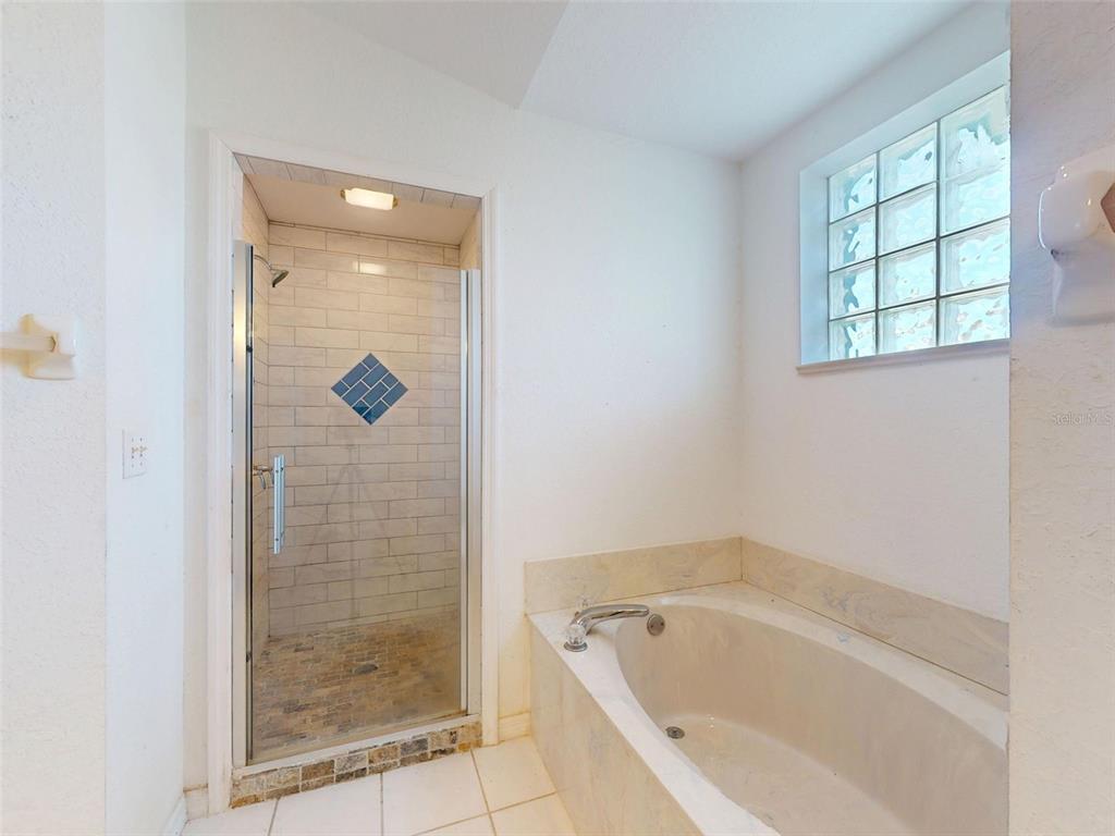 7558 Southwest 103rd Loop Ocala, FL 34476 - Photo 17 of 38 a bathroom with a bathtub and shower