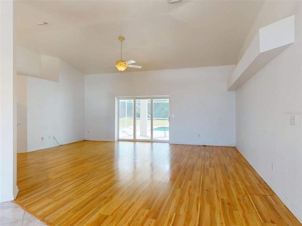 7558 Southwest 103rd Loop Ocala, FL 34476 - Photo 2 of 38 wooden floor in an empty room with a window