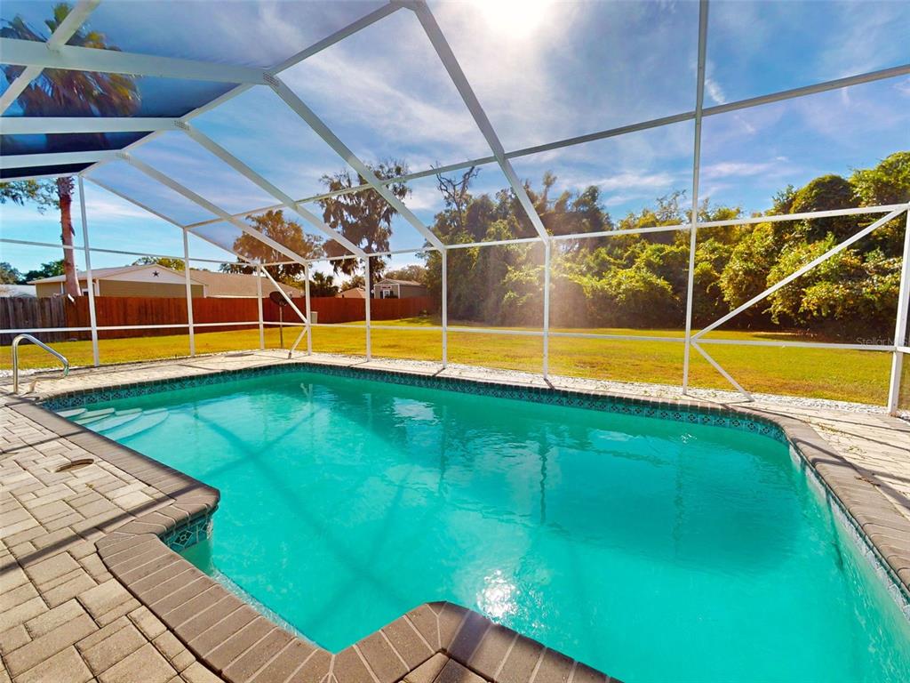7558 Southwest 103rd Loop Ocala, FL 34476 - Photo 28 of 38 a view of a swimming pool with an outdoor seating