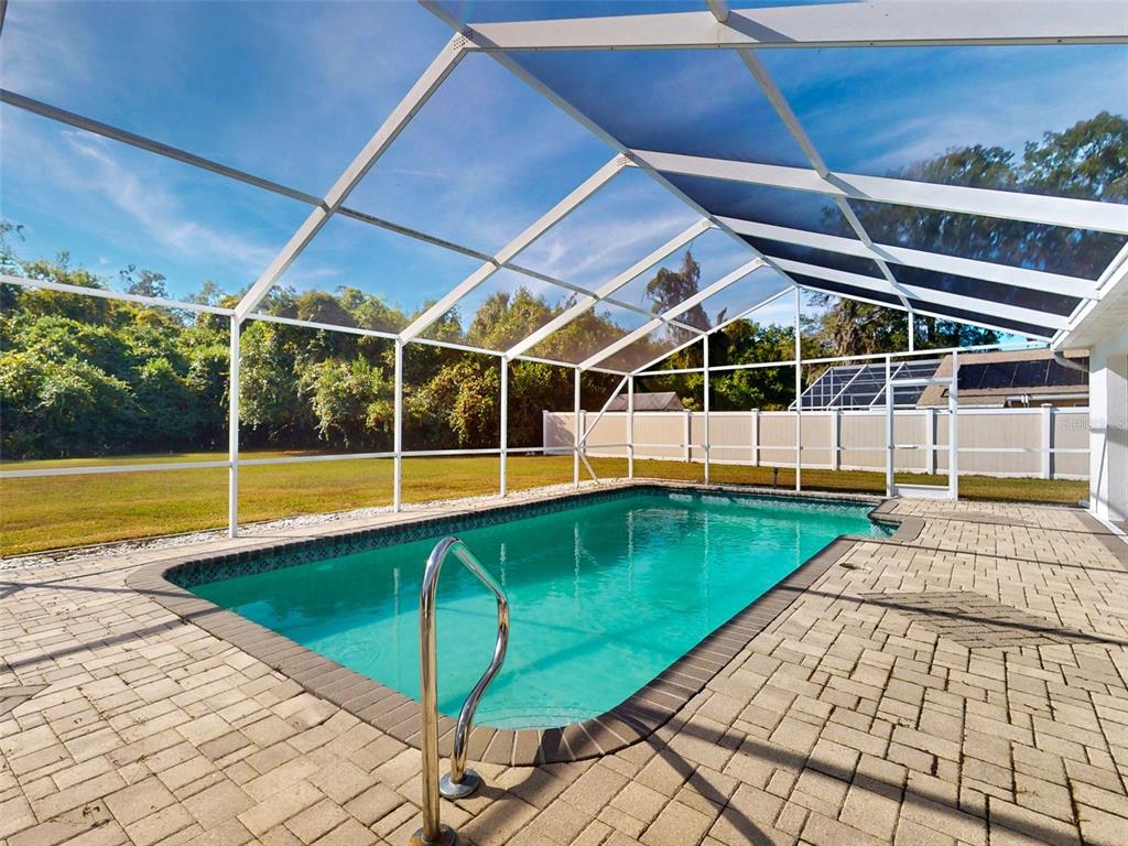 7558 Southwest 103rd Loop Ocala, FL 34476 - Photo 30 of 38 a view of a swimming pool with a yard