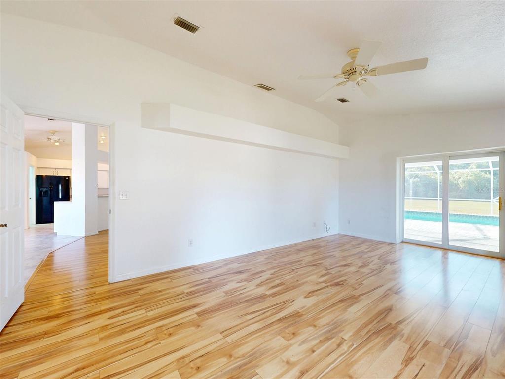 7558 Southwest 103rd Loop Ocala, FL 34476 - Photo 3 of 38 a view of empty room with wooden floor and fan