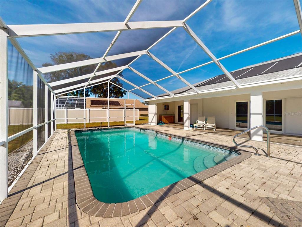 7558 Southwest 103rd Loop Ocala, FL 34476 - Photo 32 of 38 a view of a swimming pool with a patio