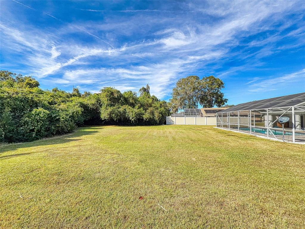 7558 Southwest 103rd Loop Ocala, FL 34476 - Photo 35 of 38 a view of a swimming pool with an outdoor seating