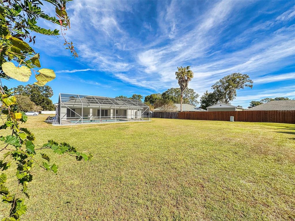 7558 Southwest 103rd Loop Ocala, FL 34476 - Photo 38 of 38 a front view of a house with a big yard