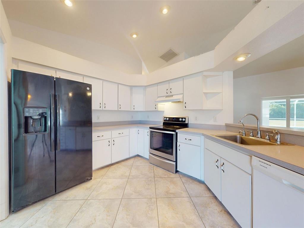 7558 Southwest 103rd Loop Ocala, FL 34476 - Photo 6 of 38 a kitchen with a sink stainless steel appliances and cabinets