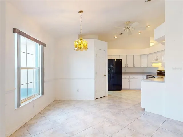 a view of a kitchen with a sink and refrigerator