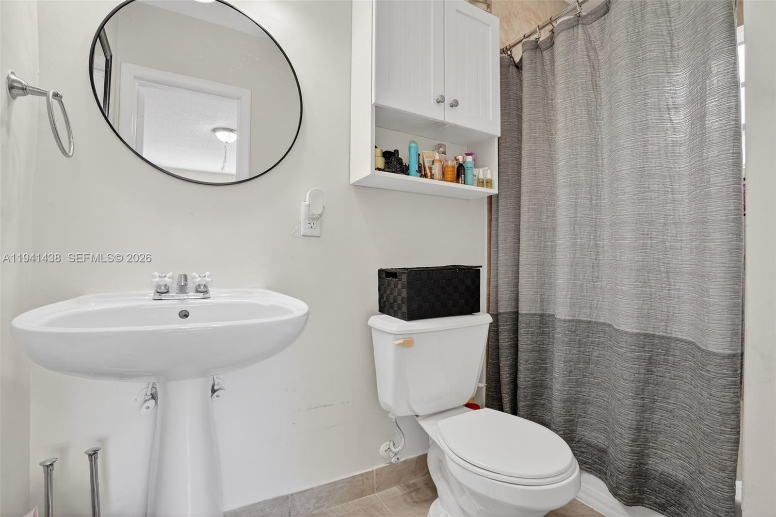 8500 Southwest 16th Street Miami, FL 33155 - Photo 16 of 26 a bathroom with a toilet a sink and a mirror