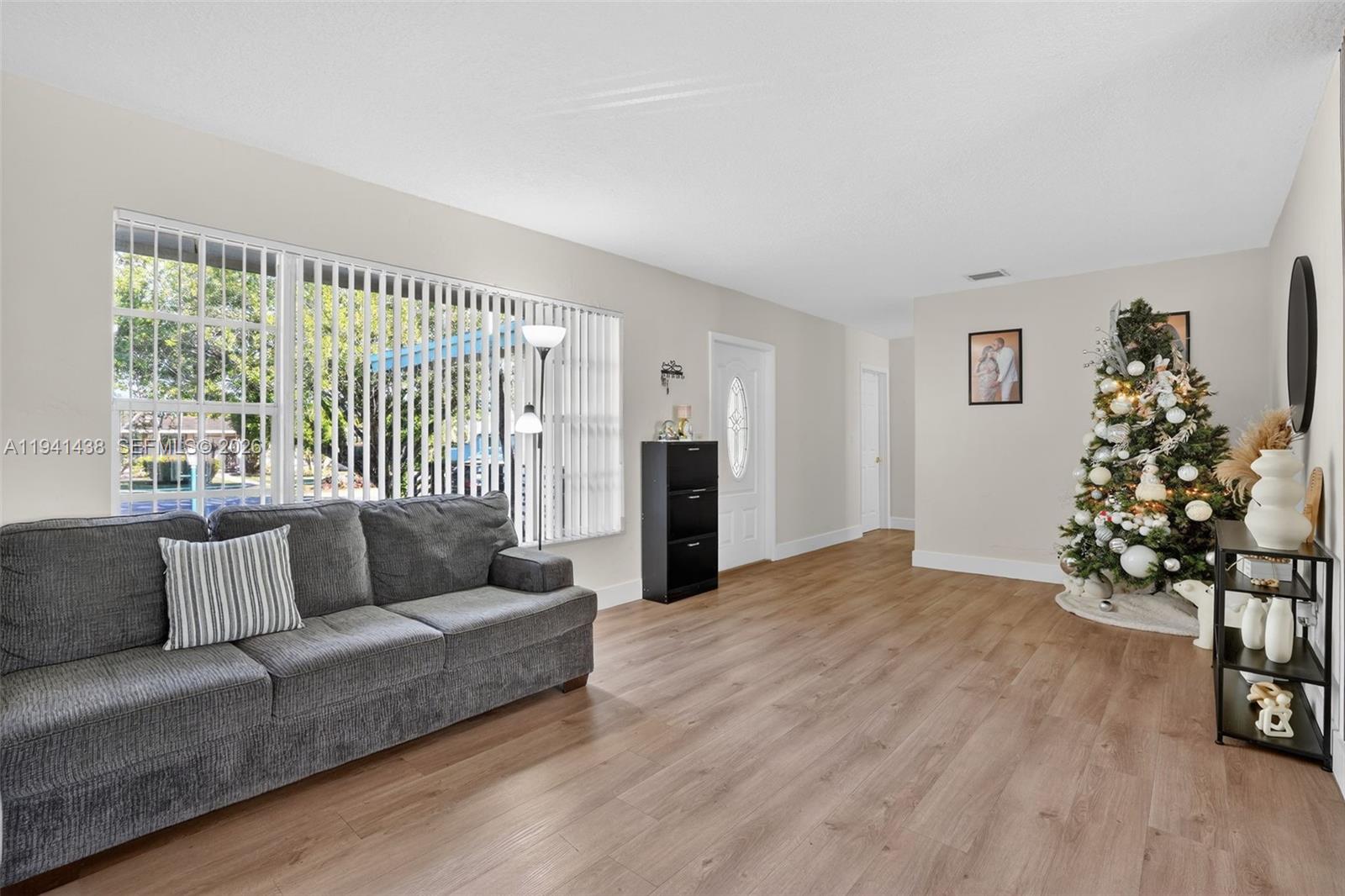 8500 Southwest 16th Street Miami, FL 33155 - Photo 5 of 26 a living room with furniture and a large window