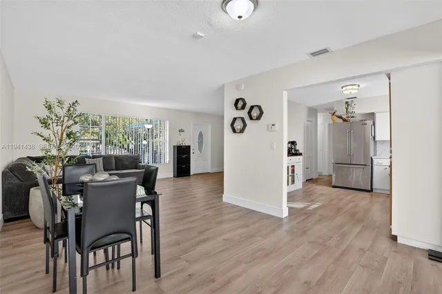 a view of a dining room with furniture and wooden floor