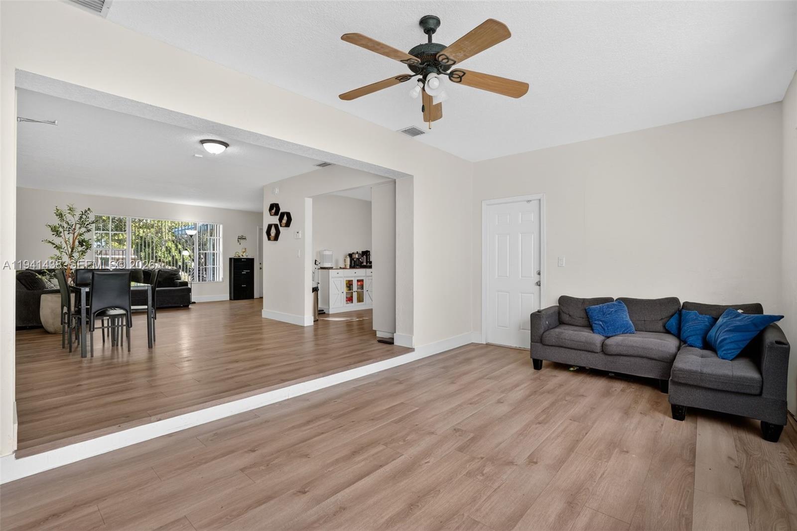 8500 Southwest 16th Street Miami, FL 33155 - Photo 8 of 26 a living room with furniture and a large window with wooden floor