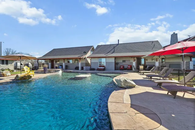 a spacious bedroom with a bed and a chandelier