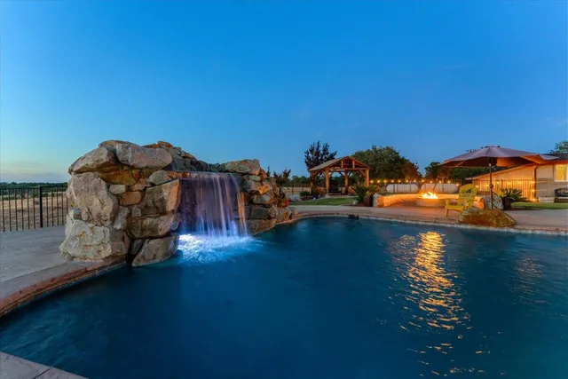 an aerial view of a house with a garden and lake view