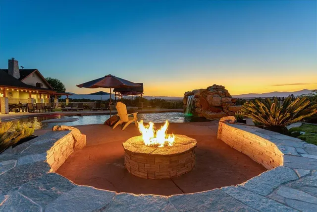 a front view of a house with a yard and table and chairs