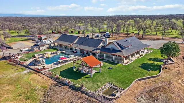 a view of a house with swimming pool and a yard