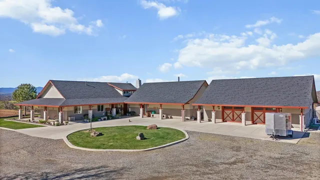 a kitchen with kitchen island granite countertop a large counter top stainless steel appliances and cabinets