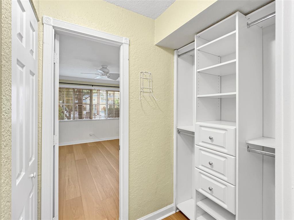 1515 East Broward Boulevard, Unit 107 Fort Lauderdale, FL 33301 - Photo 13 of 36 Walk-in closet with built-in shelving and custom storage solutions.