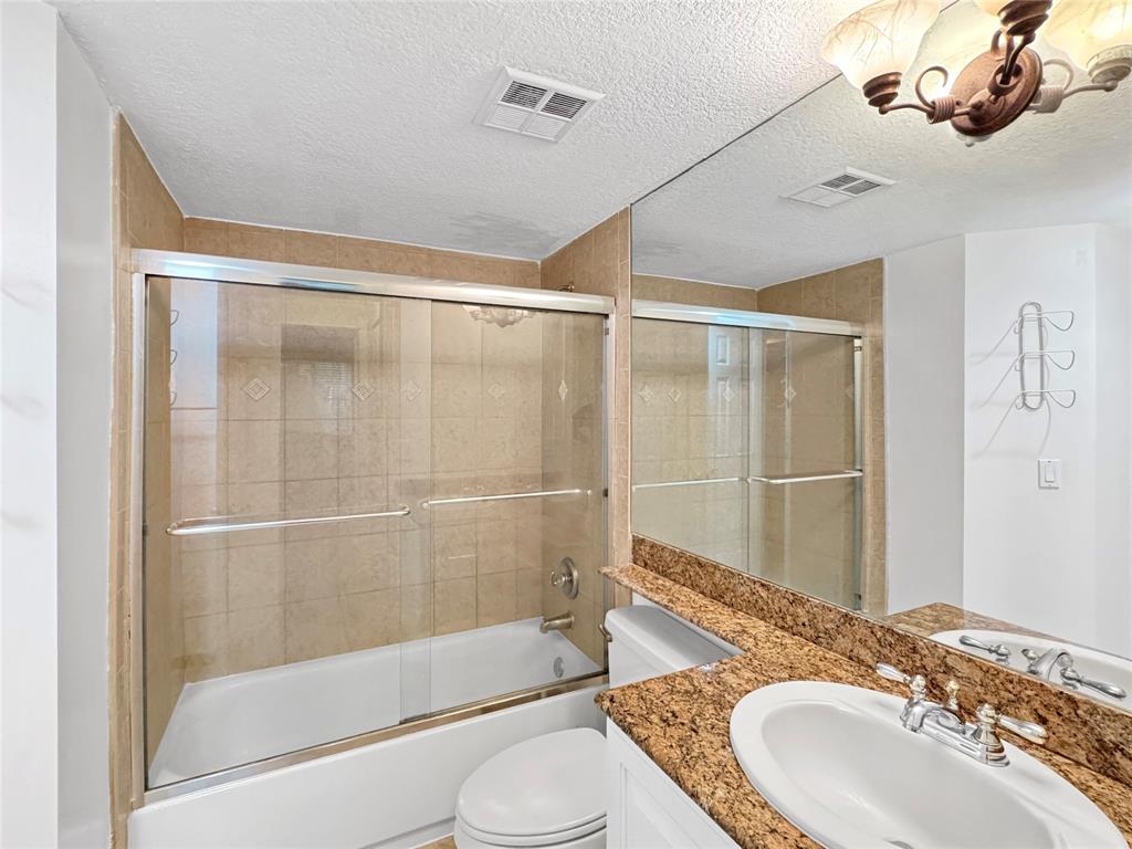 1515 East Broward Boulevard, Unit 107 Fort Lauderdale, FL 33301 - Photo 15 of 36 Elegant bath with granite counters and a versatile tub-shower combination.
