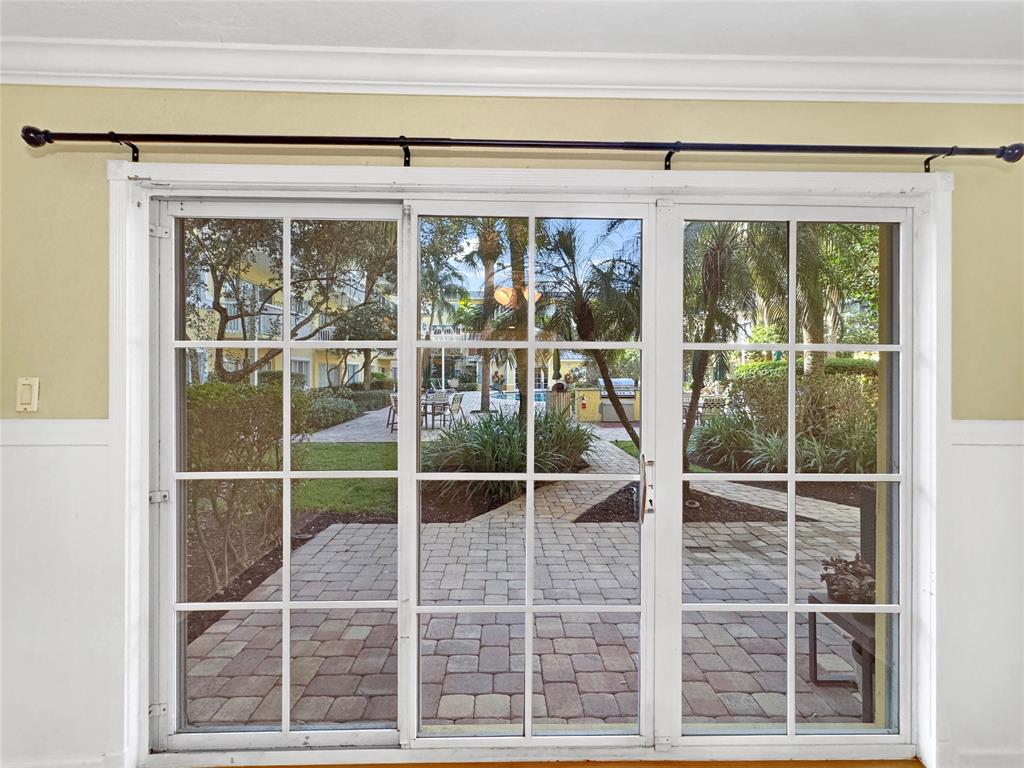 1515 East Broward Boulevard, Unit 107 Fort Lauderdale, FL 33301 - Photo 17 of 36 Enjoy direct views of the tropical pool courtyard from your living room.