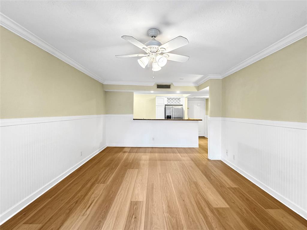 1515 East Broward Boulevard, Unit 107 Fort Lauderdale, FL 33301 - Photo 4 of 36 Spacious living room showcases an open view of the kitchen and breakfast bar, ideal for comfortable daily living.