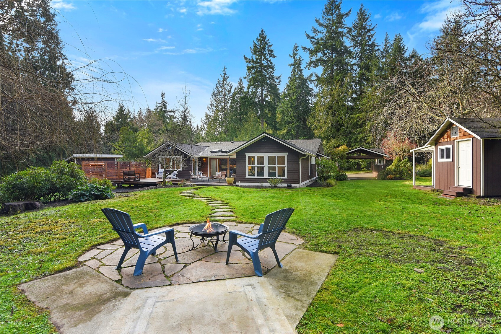 6133 Lariat Loop Bainbridge Island, WA 98110 - Photo 1 of 40 a view of house with backyard and outdoor seating