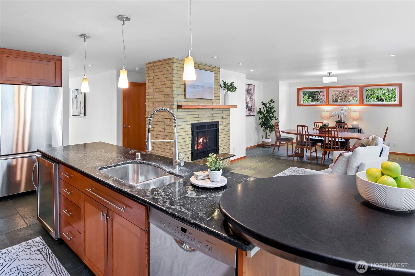 6133 Lariat Loop Bainbridge Island, WA 98110 - Photo 17 of 40 a kitchen with granite countertop a sink a counter top space and living room