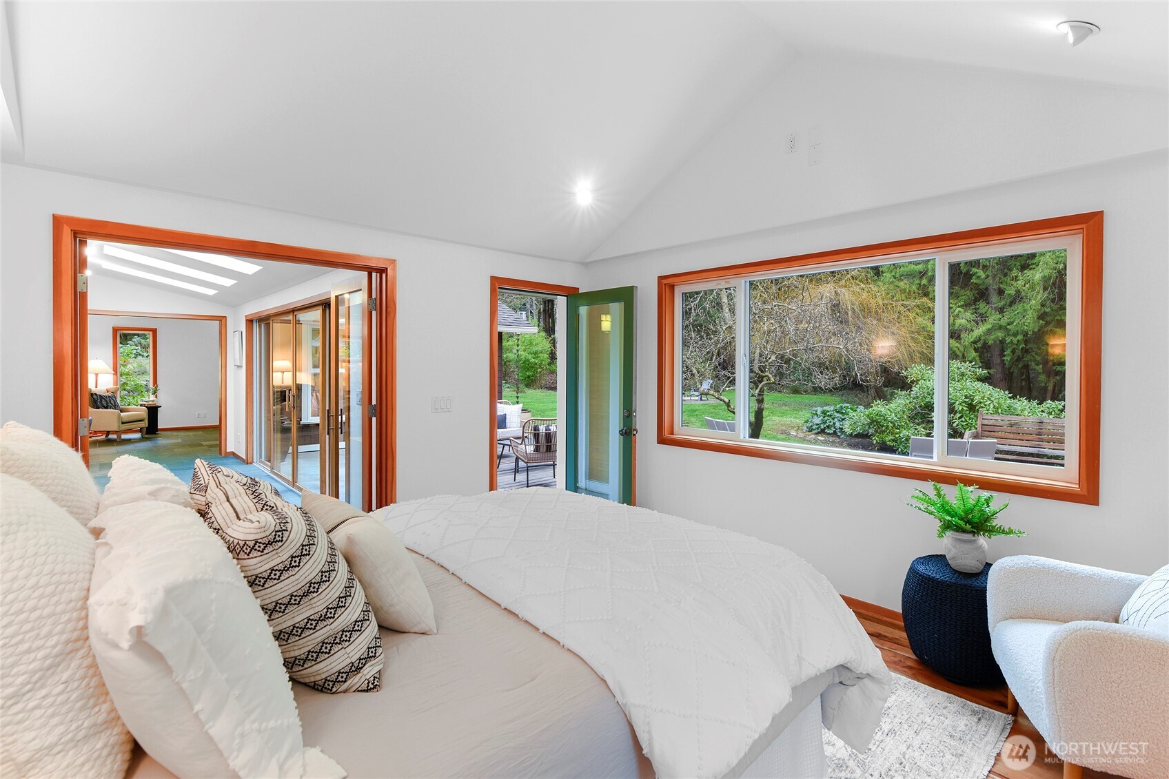 6133 Lariat Loop Bainbridge Island, WA 98110 - Photo 23 of 40 a bedroom with a large bed and a large window