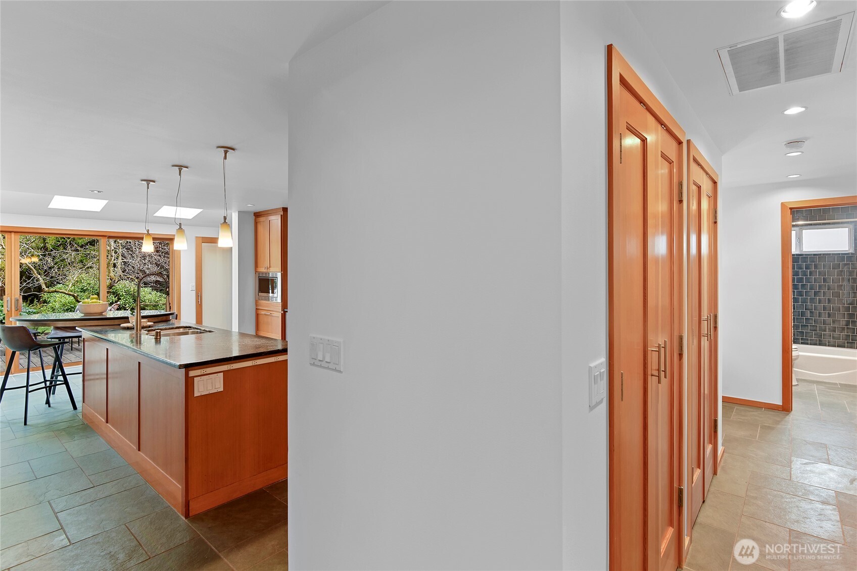 6133 Lariat Loop Bainbridge Island, WA 98110 - Photo 32 of 40 a kitchen with stainless steel appliances granite countertop a refrigerator and a stove top oven