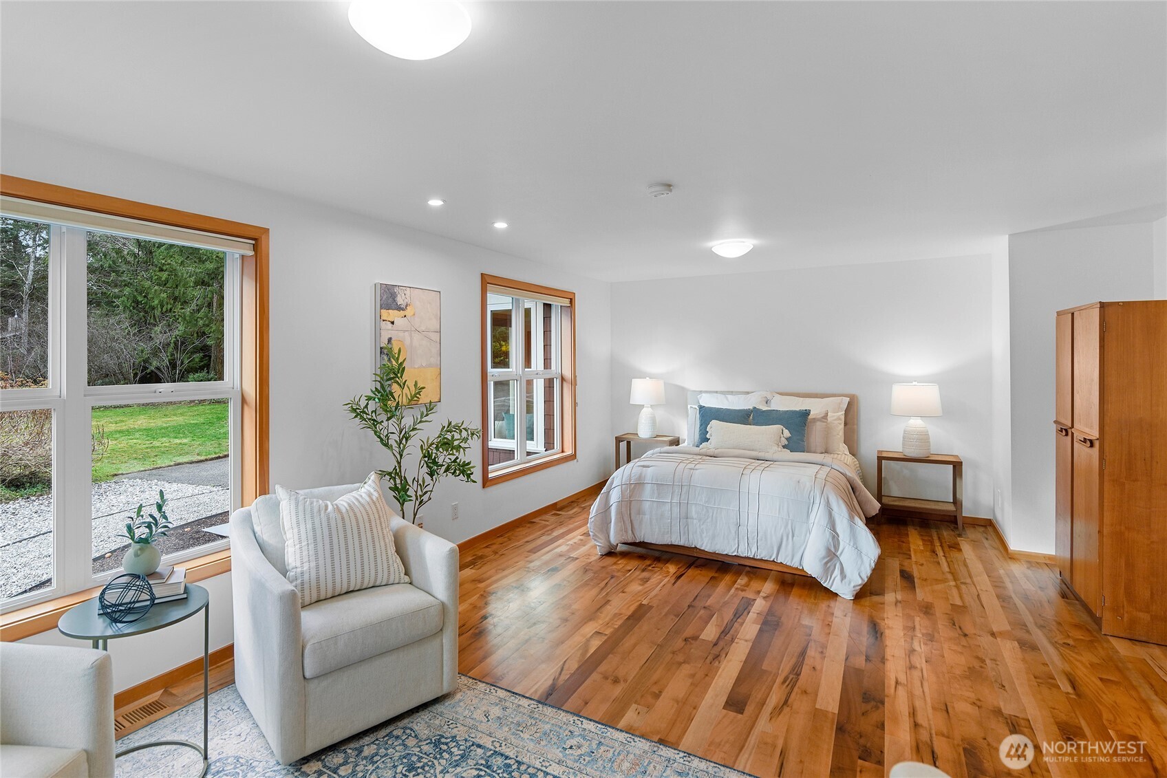 6133 Lariat Loop Bainbridge Island, WA 98110 - Photo 34 of 40 a bedroom with a large bed and a large window