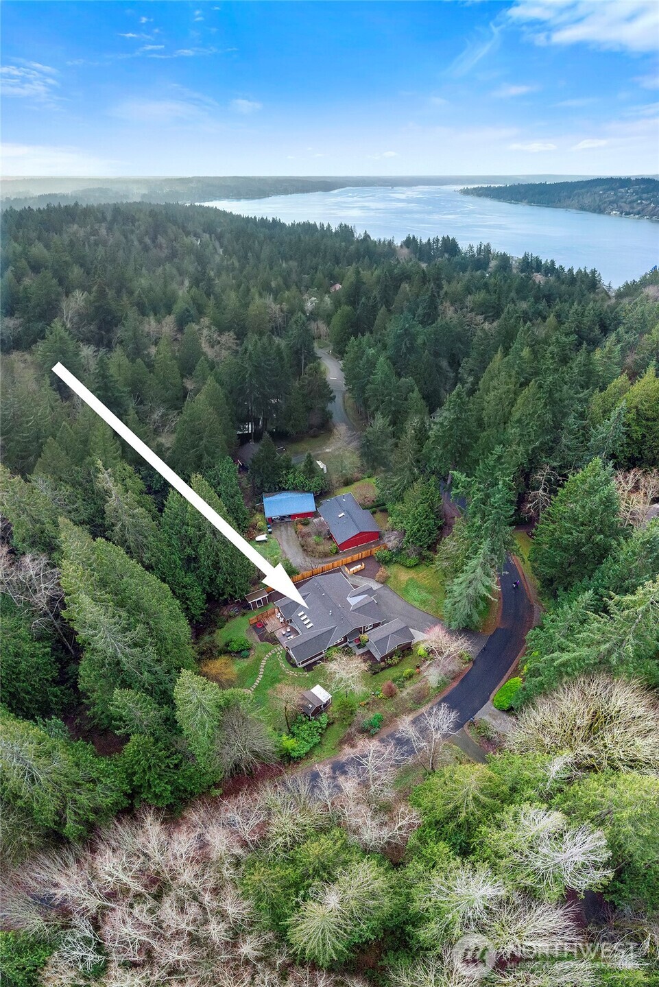 6133 Lariat Loop Bainbridge Island, WA 98110 - Photo 5 of 40 a view of a city with lush green forest