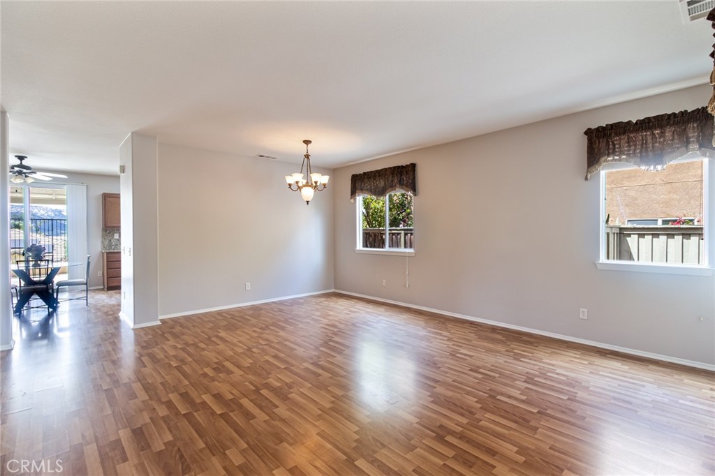 46321 Sharon Street Temecula, CA 92592 - Photo 11 of 40 an empty room with wooden floor and windows