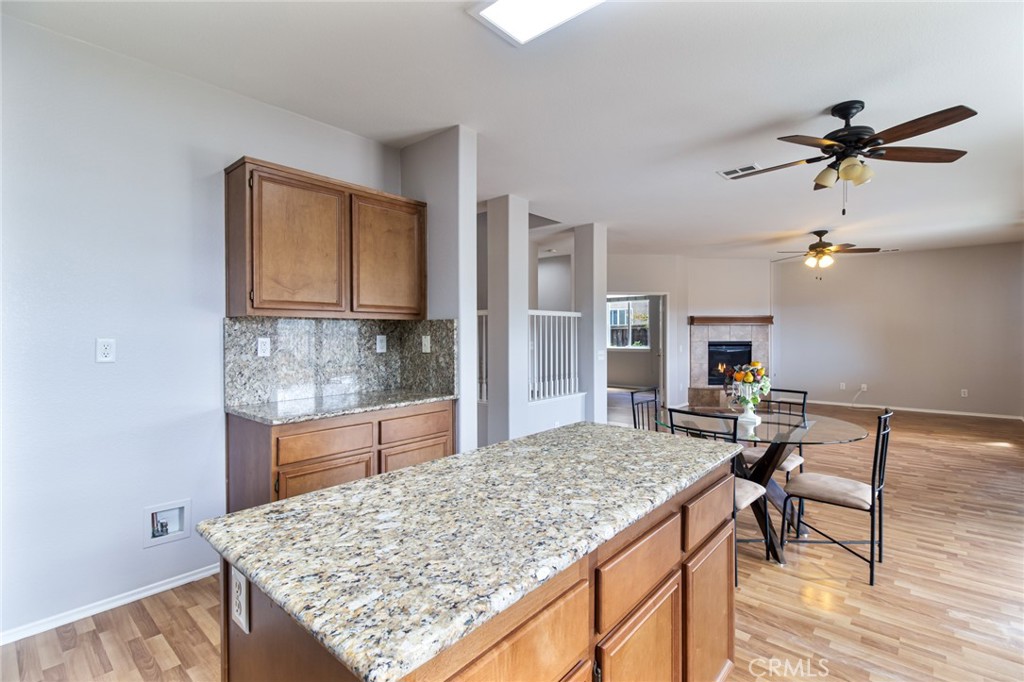 46321 Sharon Street Temecula, CA 92592 - Photo 17 of 40 a view of kitchen island sink and living room