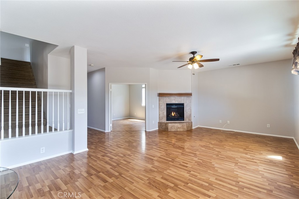 46321 Sharon Street Temecula, CA 92592 - Photo 18 of 40 a view of an empty room with wooden floor and fireplace