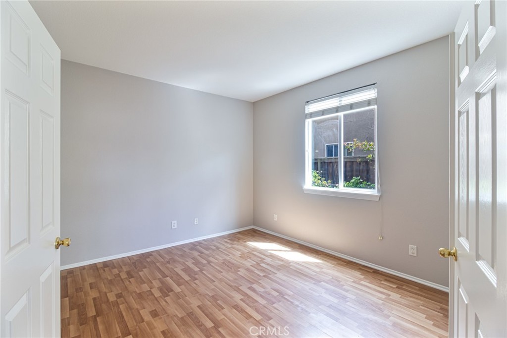 46321 Sharon Street Temecula, CA 92592 - Photo 20 of 40 a view of an empty room with wooden floor and a window