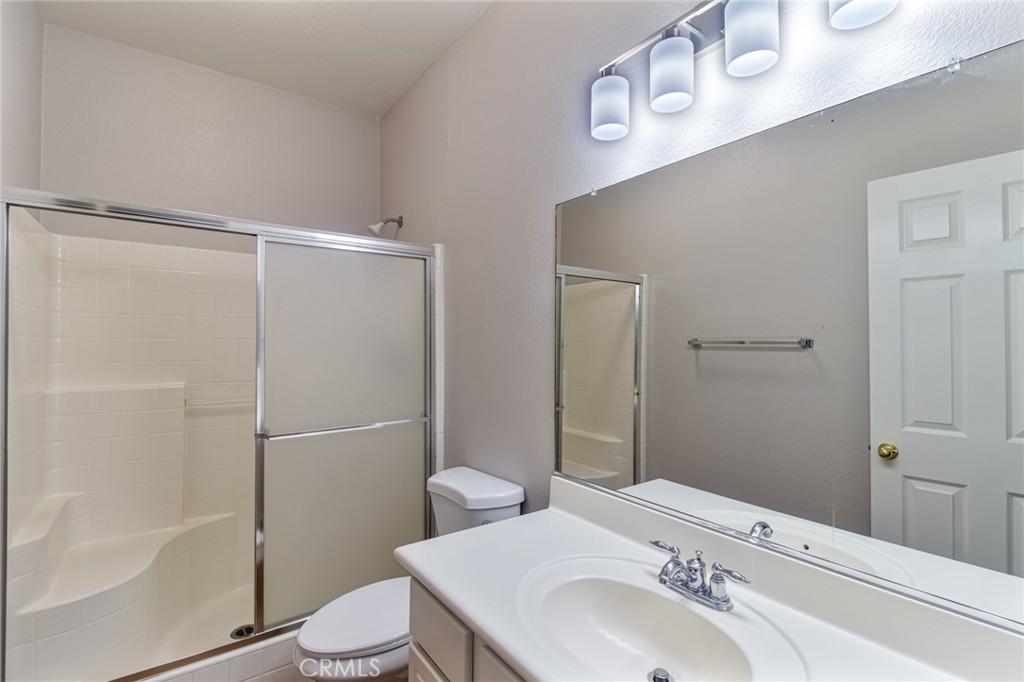 46321 Sharon Street Temecula, CA 92592 - Photo 23 of 40 a bathroom with a sink toilet and shower